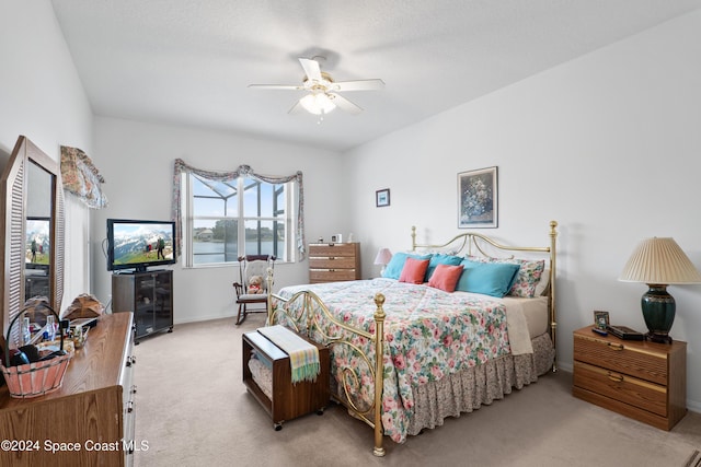 bedroom featuring ceiling fan and light carpet