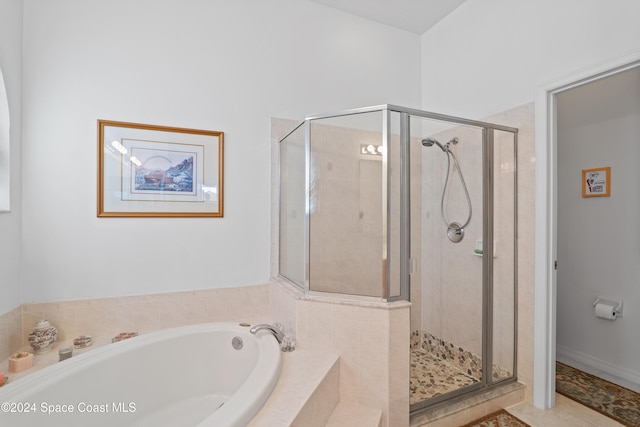 bathroom featuring independent shower and bath