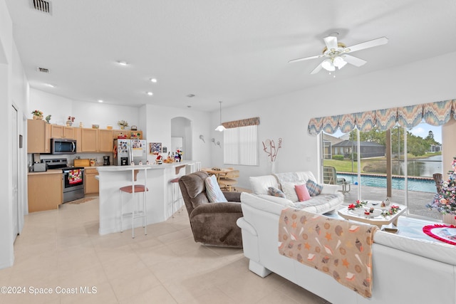 living room with ceiling fan and light tile patterned floors