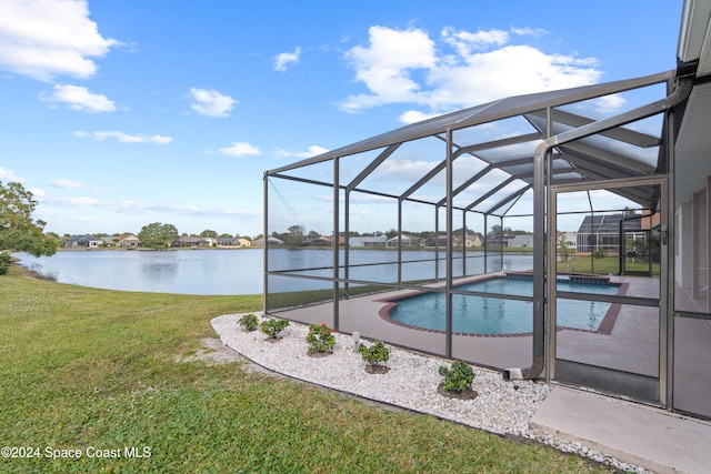 view of swimming pool with a lawn, a lanai, and a water view