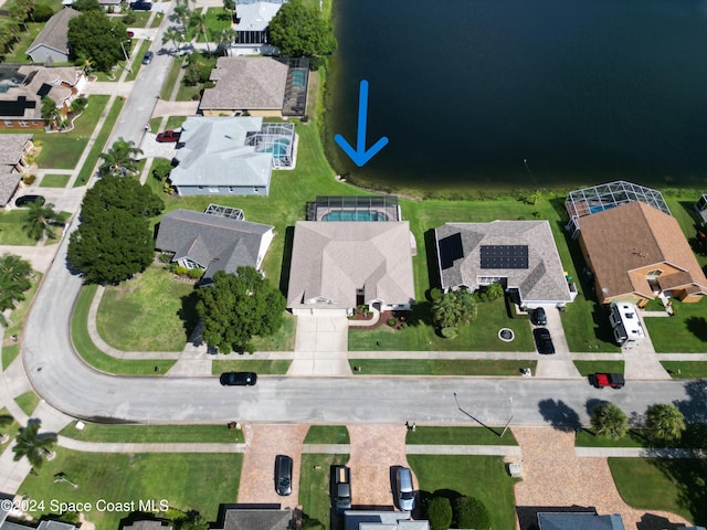 birds eye view of property with a water view