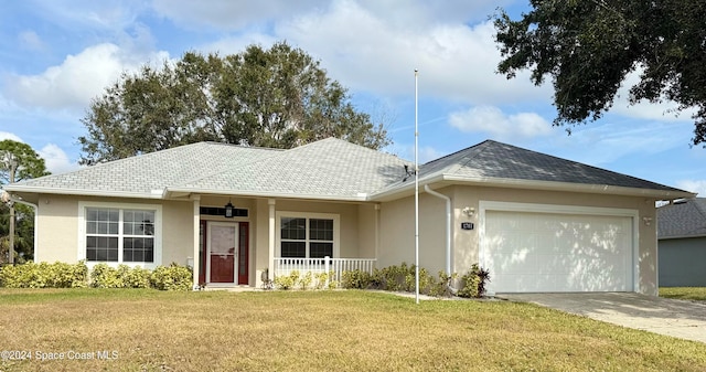 single story home with a porch, a garage, and a front lawn