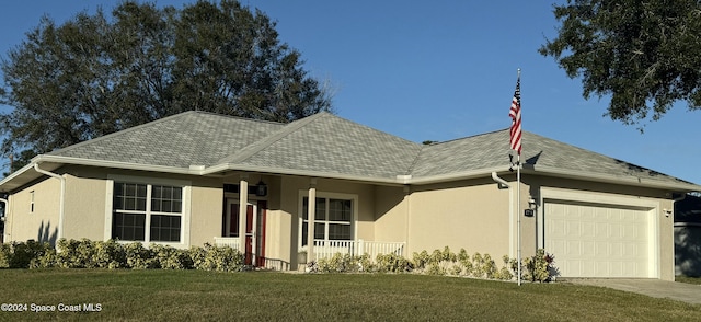 ranch-style house featuring a porch, a garage, and a front lawn