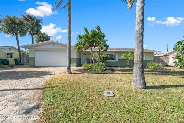 single story home with a front yard and a garage