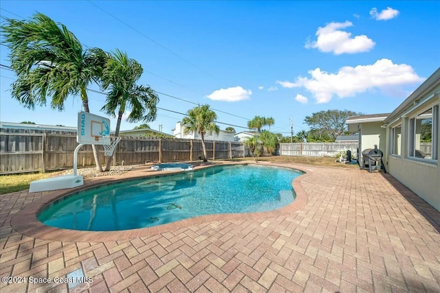 view of swimming pool with a patio and a hot tub