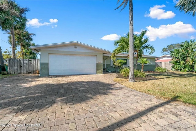 view of front of property with a garage and a front yard