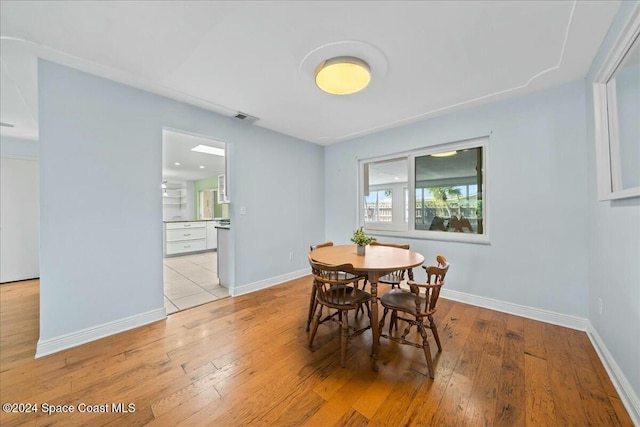 dining space with light hardwood / wood-style floors