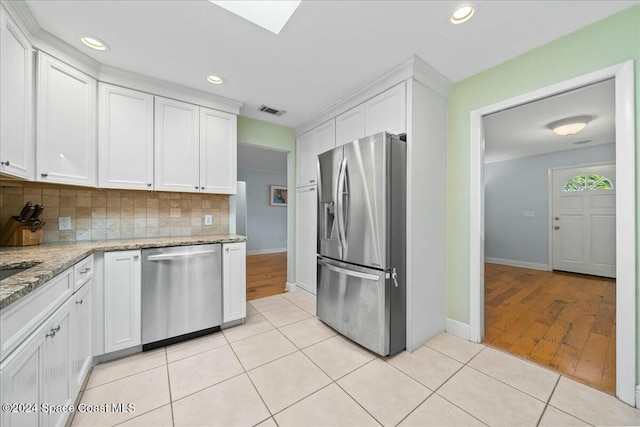 kitchen featuring white cabinetry, light hardwood / wood-style flooring, and appliances with stainless steel finishes