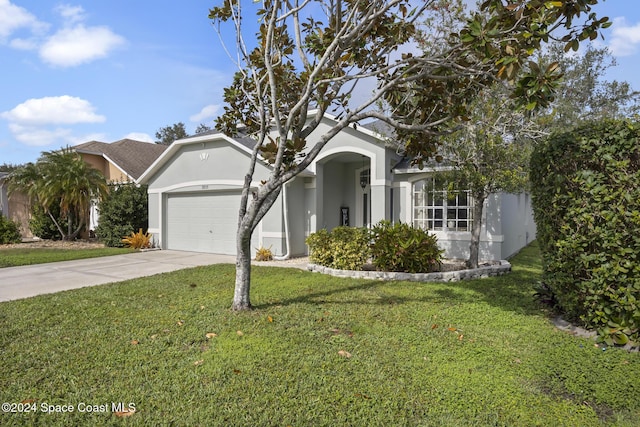 view of front facade with a front yard and a garage