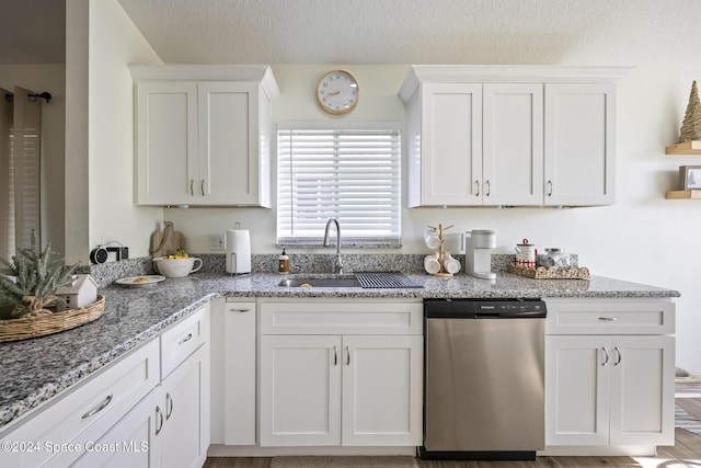 kitchen with dishwasher, sink, light stone counters, white cabinets, and light wood-type flooring