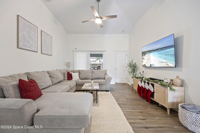 living room featuring ceiling fan, high vaulted ceiling, and hardwood / wood-style flooring