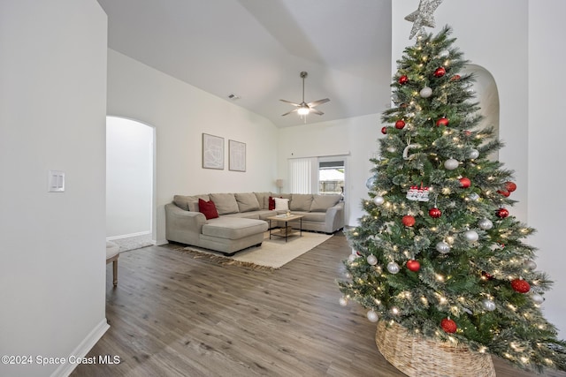 living room featuring hardwood / wood-style floors, ceiling fan, and vaulted ceiling