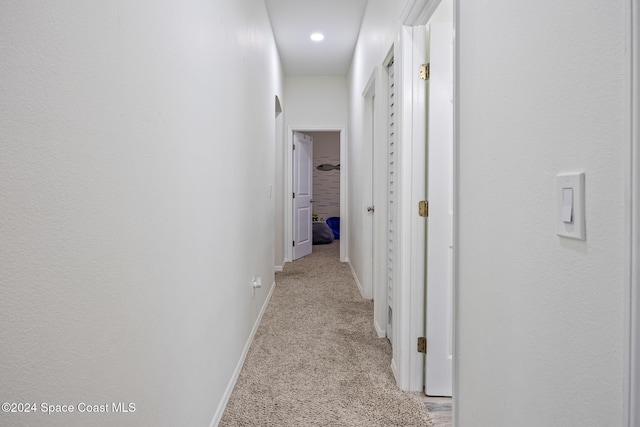 hall featuring light colored carpet