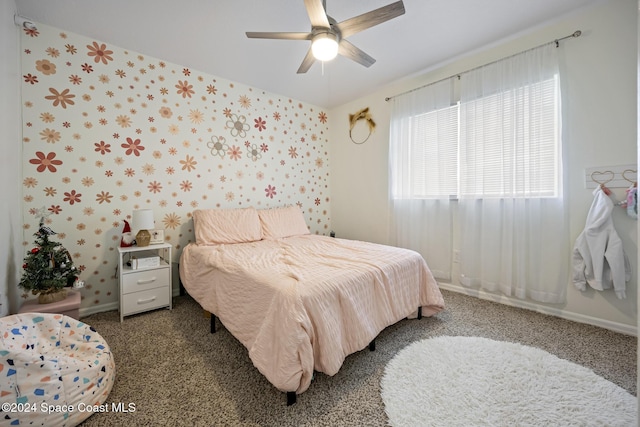 bedroom with ceiling fan and dark colored carpet