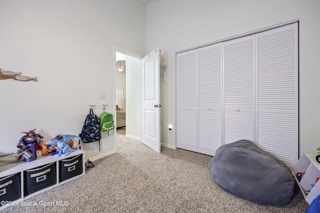 game room with carpet flooring and a high ceiling