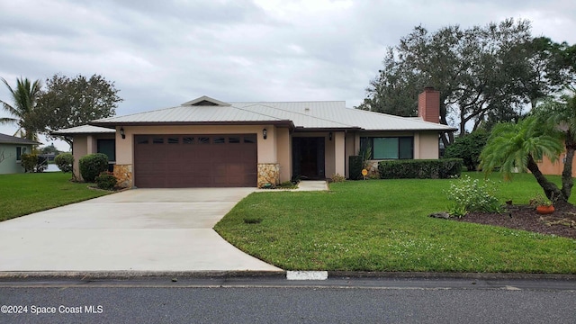 view of front of property with a front lawn and a garage