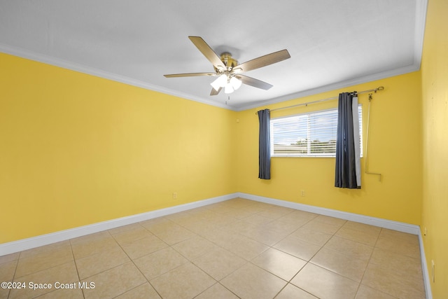 spare room featuring light tile patterned floors, ceiling fan, and ornamental molding