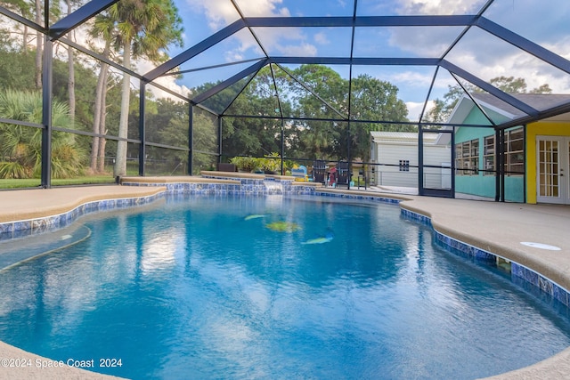 view of swimming pool with a lanai and a patio area