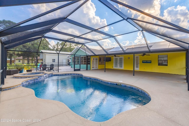 view of swimming pool featuring a lanai, a patio area, an in ground hot tub, and french doors