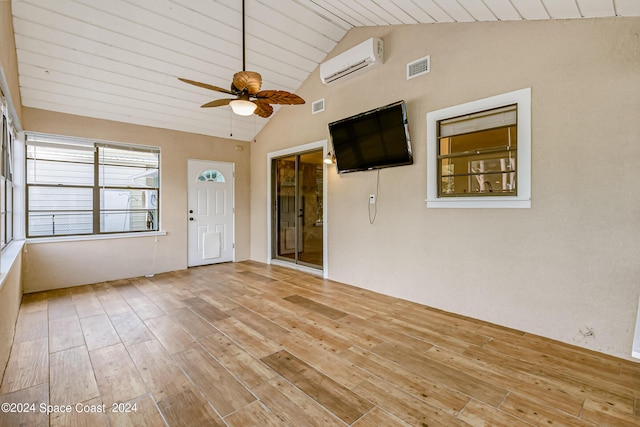 unfurnished sunroom featuring ceiling fan, wooden ceiling, a wall unit AC, and vaulted ceiling