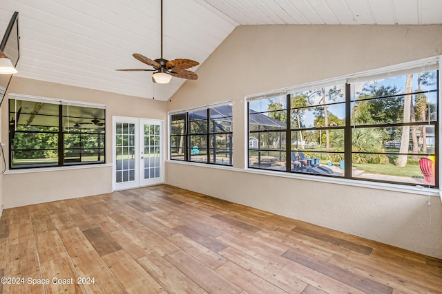 unfurnished sunroom with french doors, vaulted ceiling, and a healthy amount of sunlight