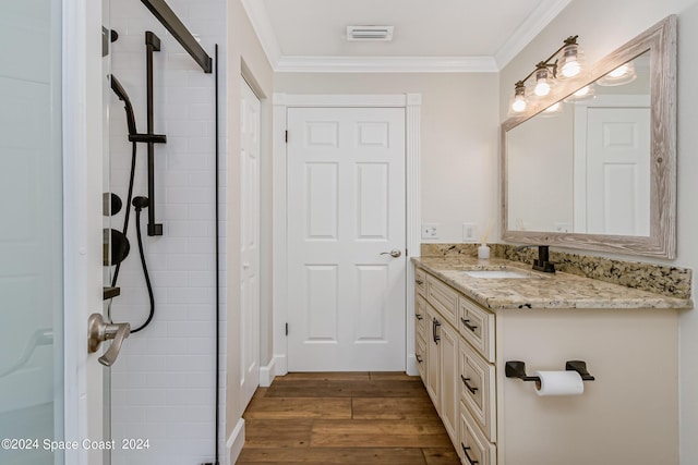 bathroom with hardwood / wood-style floors, vanity, and ornamental molding