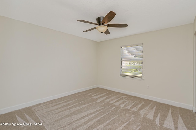 empty room with ceiling fan and light colored carpet