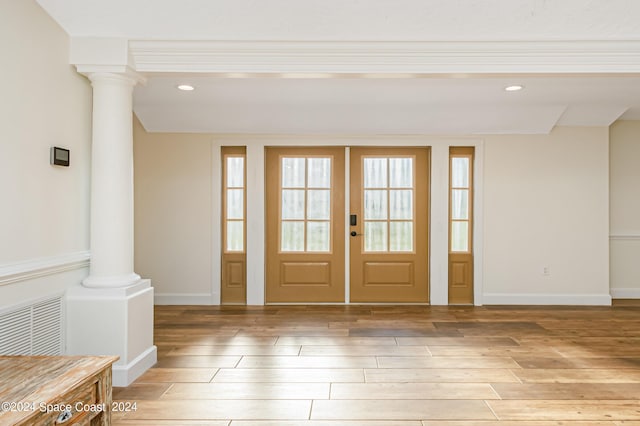 doorway to outside featuring ornate columns, a wealth of natural light, french doors, and hardwood / wood-style flooring