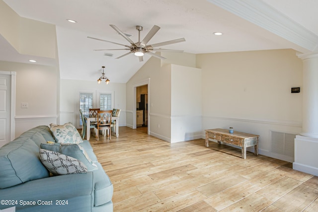 living room featuring light hardwood / wood-style flooring, ceiling fan, lofted ceiling, and ornate columns