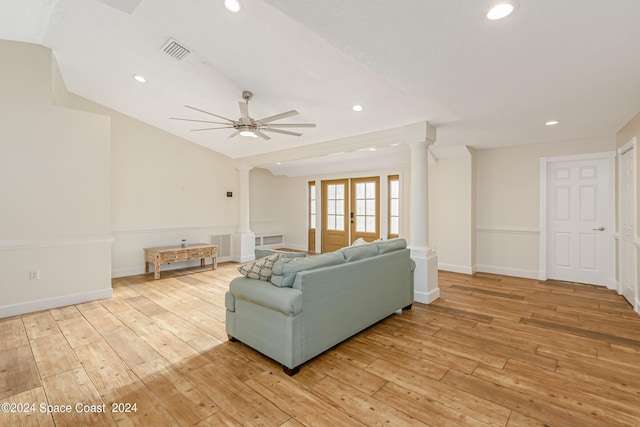 living room featuring ceiling fan, vaulted ceiling, light wood-type flooring, and french doors