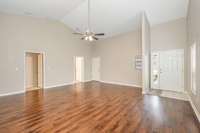 unfurnished living room with ceiling fan, dark hardwood / wood-style flooring, and high vaulted ceiling