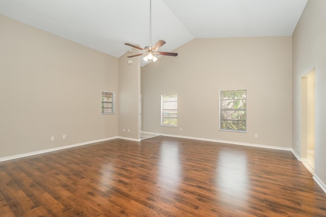 spare room featuring high vaulted ceiling, ceiling fan, and dark wood-type flooring