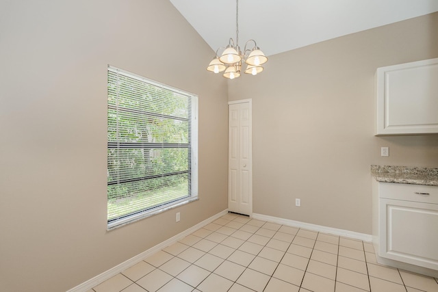 867 S Patrick Dr, Satellite Beach, FL 32937 - unfurnished dining area featuring a chandelier, plenty of natural light, lofted ceiling, and light tile patterned flooring