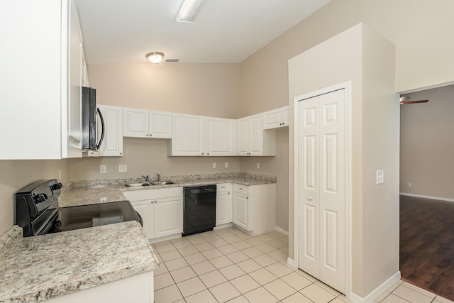 867 S Patrick Dr, Satellite Beach, FL 32937 - kitchen featuring black appliances, white cabinets, light tile patterned flooring, and a high ceiling