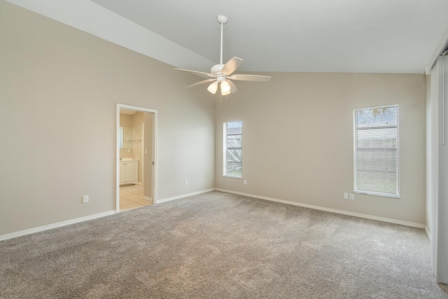 867 S Patrick Dr, Satellite Beach, FL 32937 - empty room with light colored carpet, a ceiling fan, and vaulted ceiling