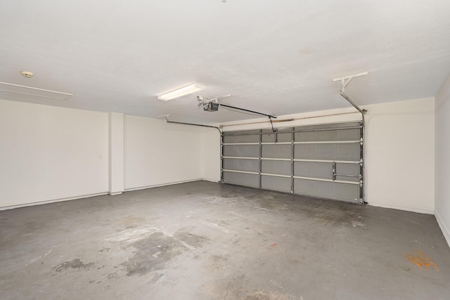 867 S Patrick Dr, Satellite Beach, FL 32937 - garage with a garage door opener and baseboards