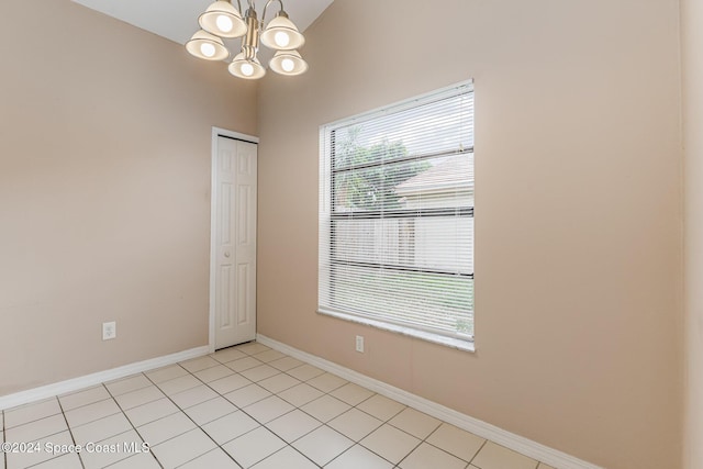867 S Patrick Dr, Satellite Beach, FL 32937 - spare room with a chandelier and light tile patterned flooring