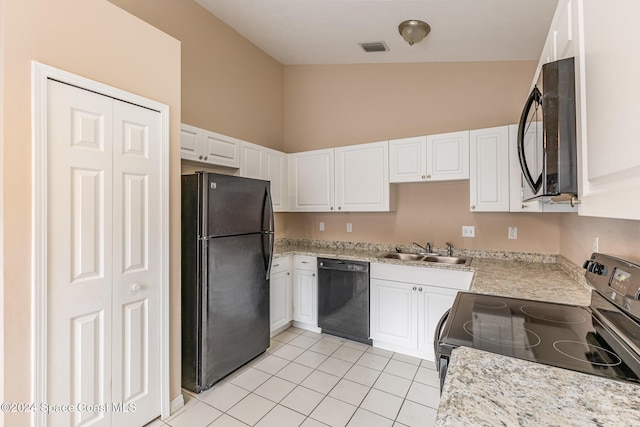 867 S Patrick Dr, Satellite Beach, FL 32937 - kitchen featuring black appliances, light tile patterned flooring, and white cabinetry