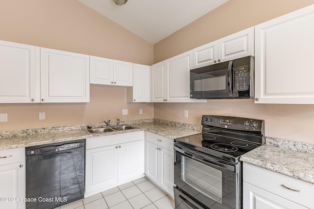 867 S Patrick Dr, Satellite Beach, FL 32937 - kitchen featuring black appliances, lofted ceiling, white cabinetry, and light tile patterned flooring