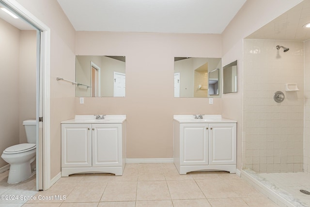 867 S Patrick Dr, Satellite Beach, FL 32937 - bathroom with a tile shower, two vanities, and tile patterned flooring