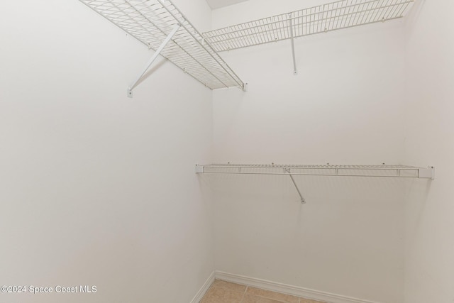 867 S Patrick Dr, Satellite Beach, FL 32937 - spacious closet featuring light tile patterned flooring