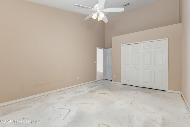 867 S Patrick Dr, Satellite Beach, FL 32937 - unfurnished bedroom with a towering ceiling, a closet, and a ceiling fan
