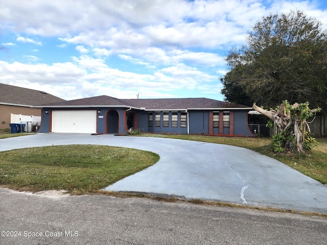 single story home with a garage and a front lawn