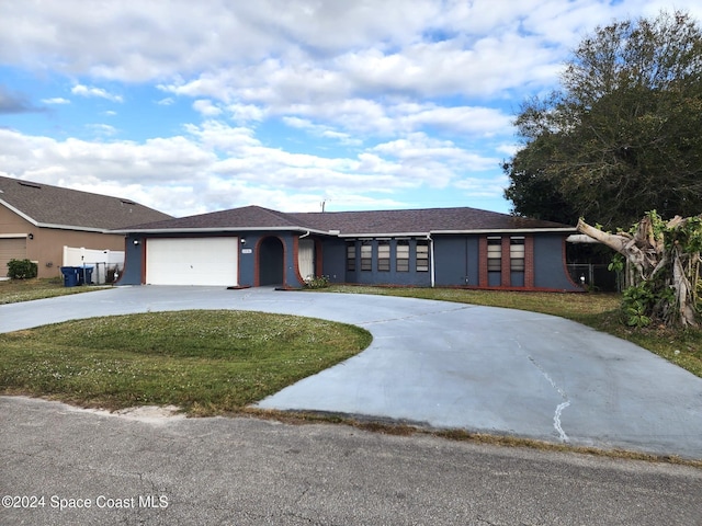 ranch-style house featuring a garage and a front yard