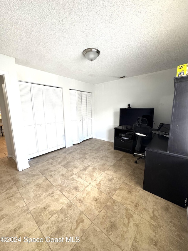 office area with a textured ceiling