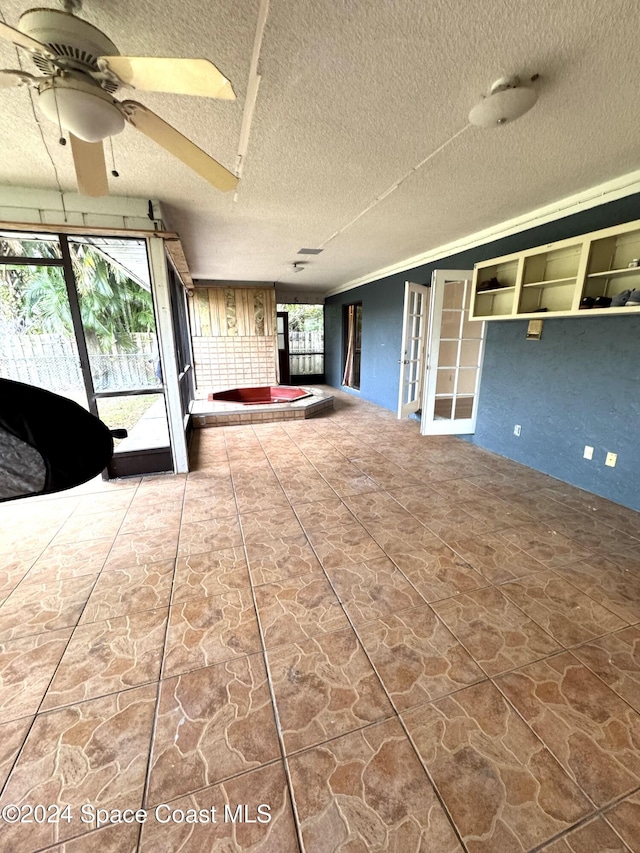 interior space with ceiling fan