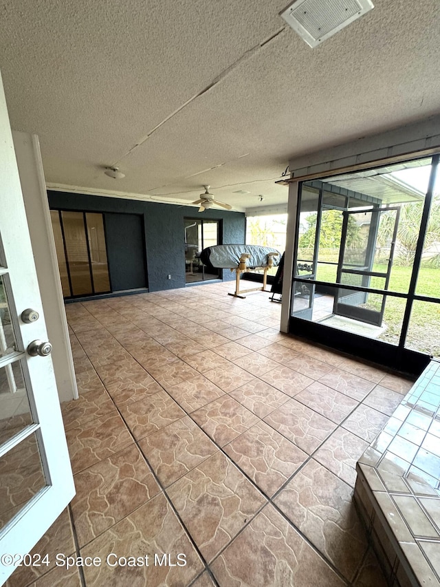 interior space with ceiling fan