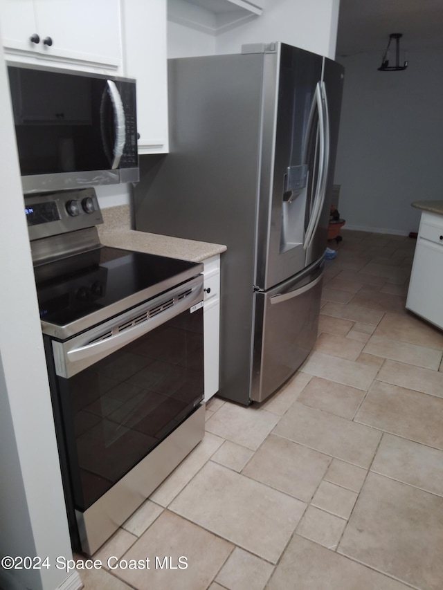 kitchen featuring appliances with stainless steel finishes and white cabinets