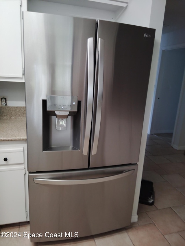 interior details featuring stainless steel fridge with ice dispenser and white cabinets