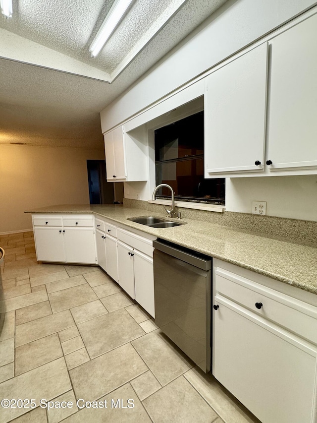 kitchen featuring sink, a textured ceiling, white cabinets, and dishwasher